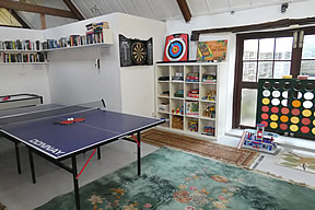 Large games room with table tennis, air hockey, darts, board games and toys