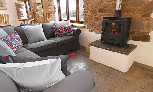 Comfortable corner sofa by the woodburner